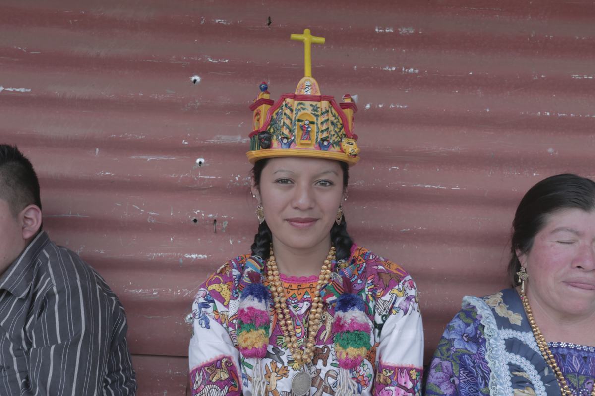 A young woman wearing a ceremonial crown