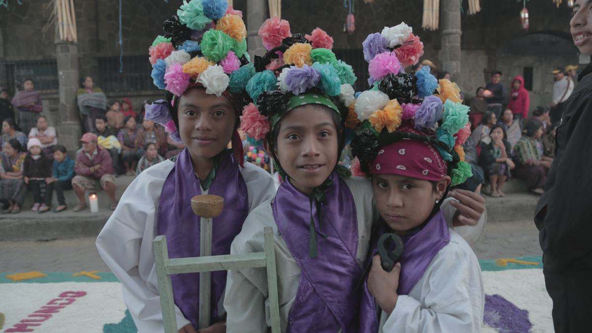 Boys wearing paper-flower crowns