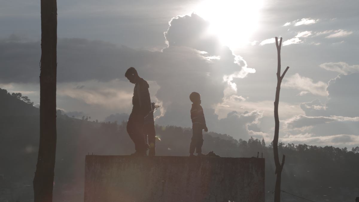 Children silhouetted against the sky